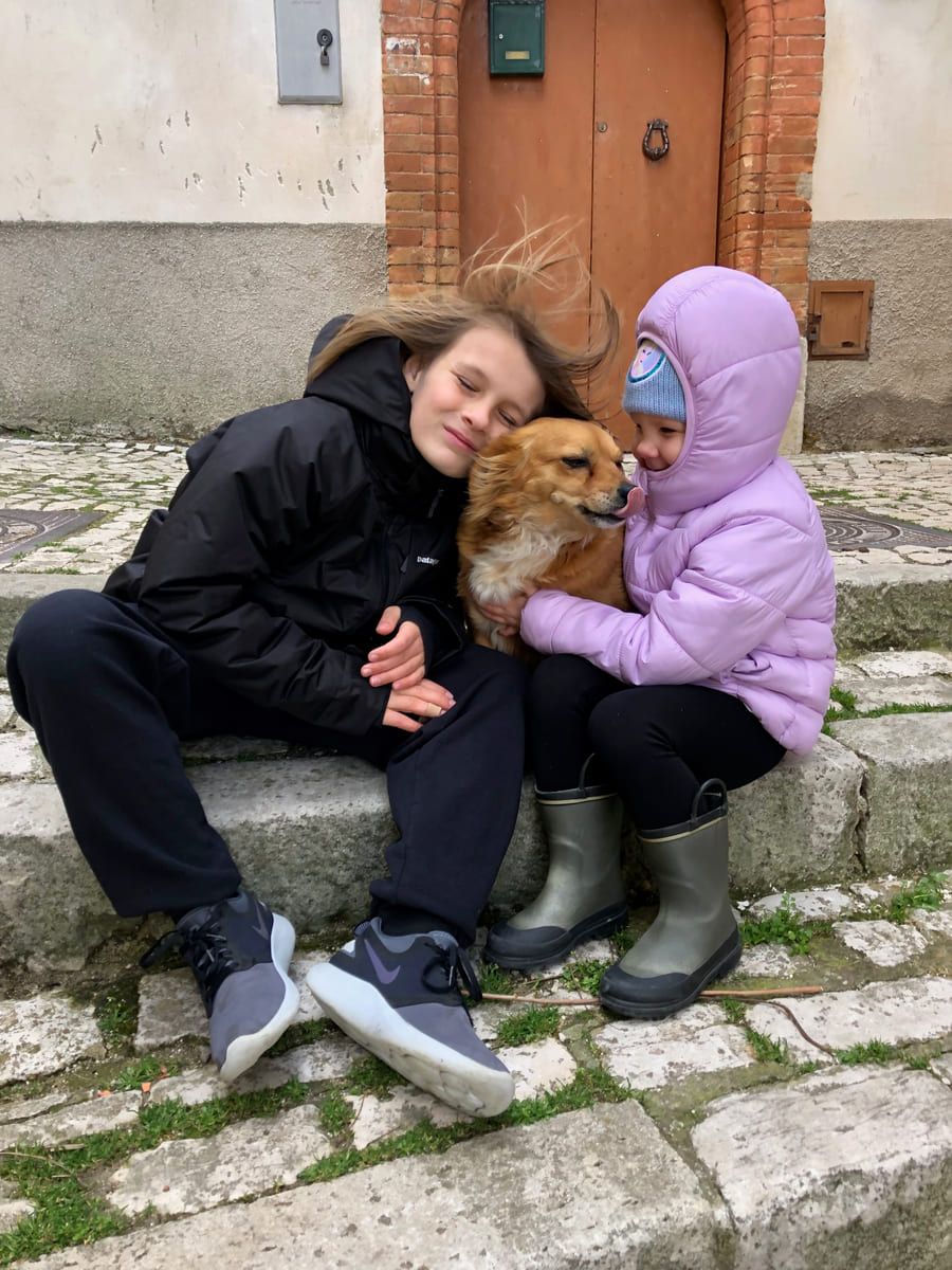 Family members embracing a rescued dog.