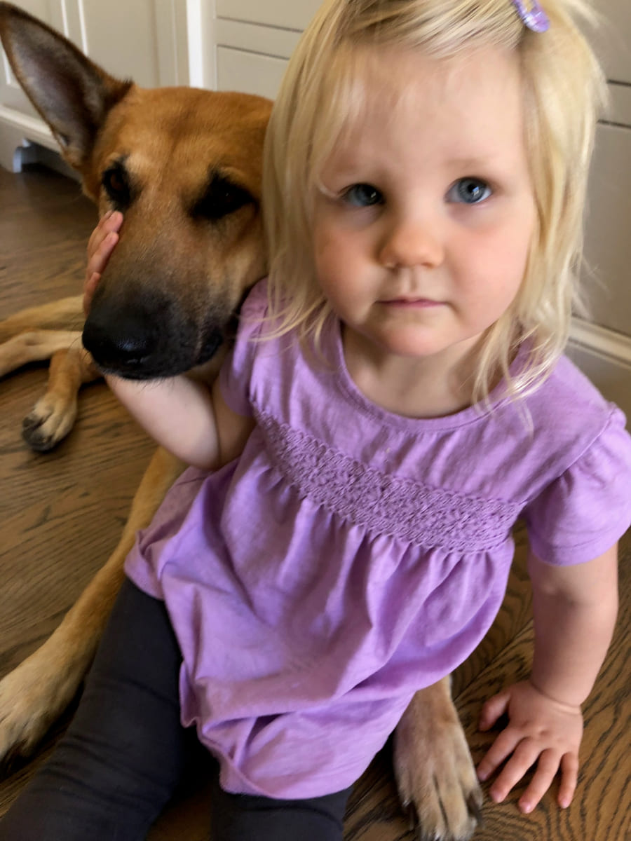 Our daughter sitting close beside a rescued dog.